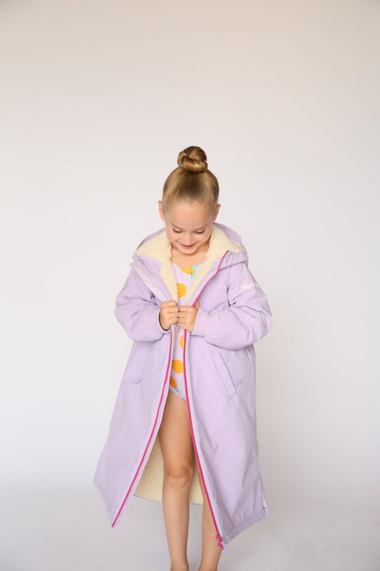 Warm, waterproof kids swim parka for swim meets, sports, and winter wear. Fleece-lined, oversized fit, under $100. Designed by moms. Fast U.S. shipping.